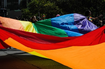 People with colorful cloth during the day
